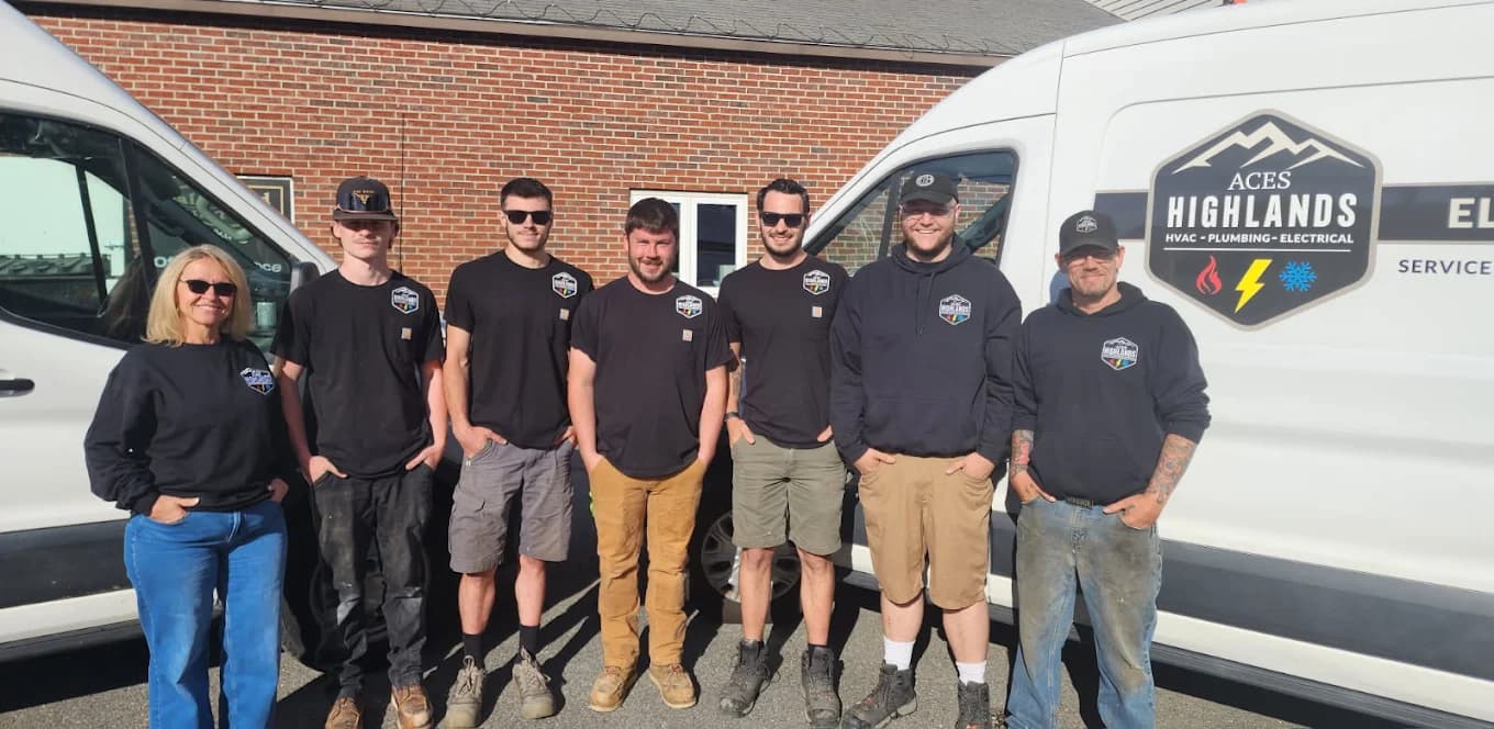 The Aces Highlands team standing in front of their service vans in Portland, Maine