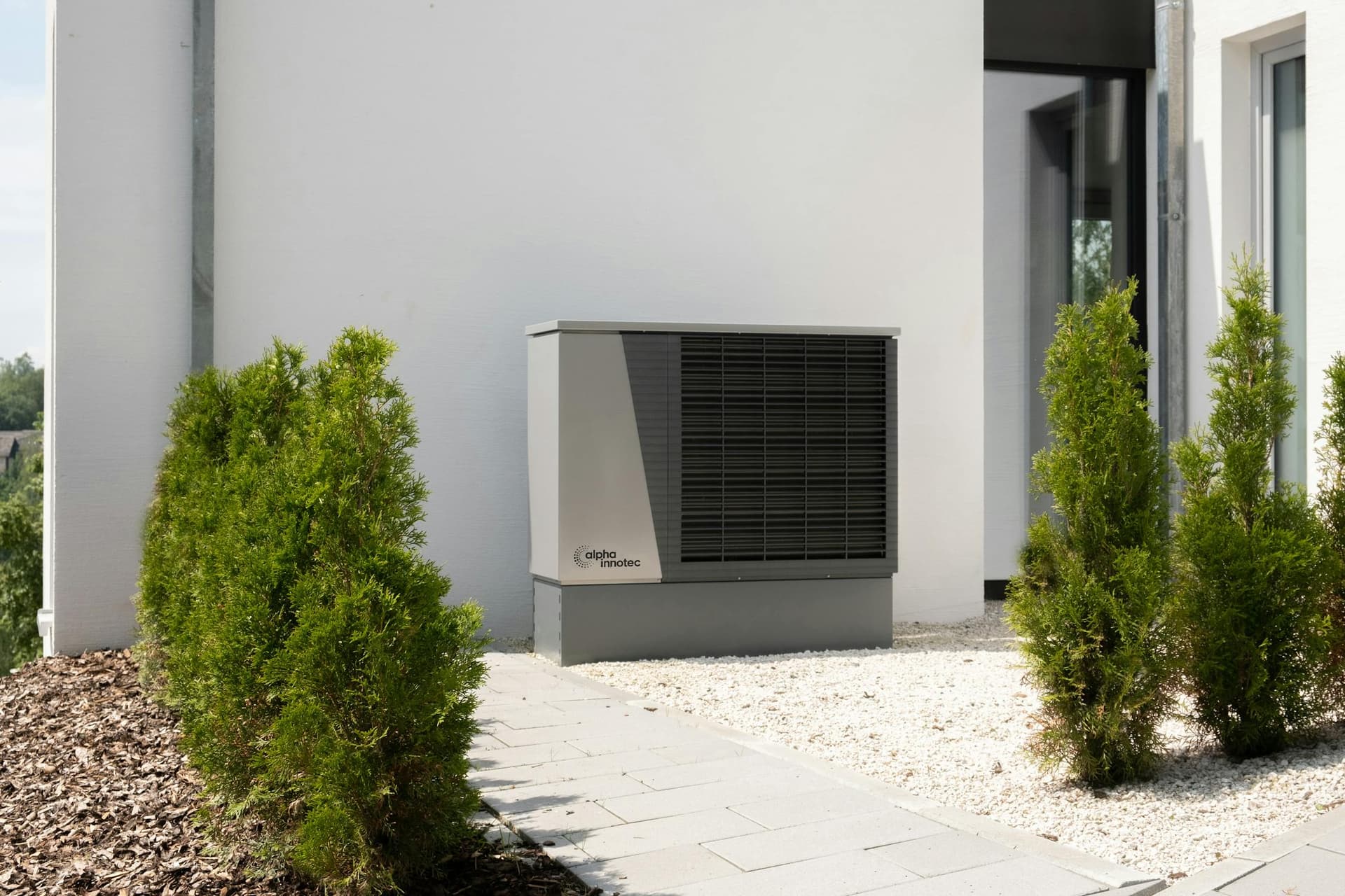 Cold-climate heat pump outdoor unit in a residential yard