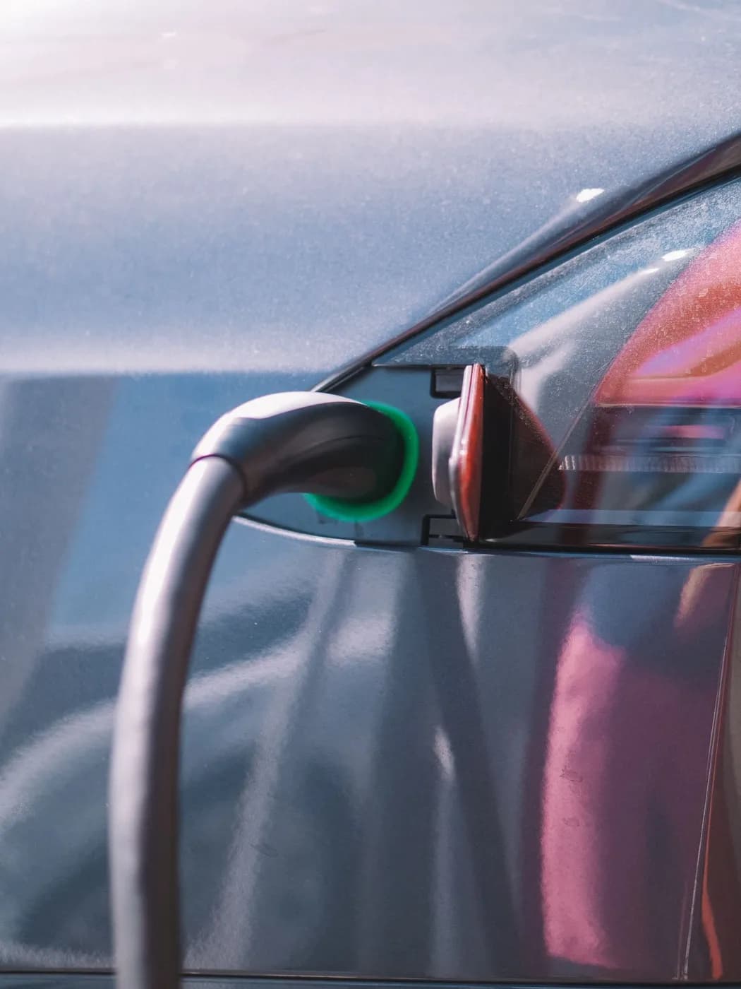 Electric vehicle charging cable plugged into a home charge port