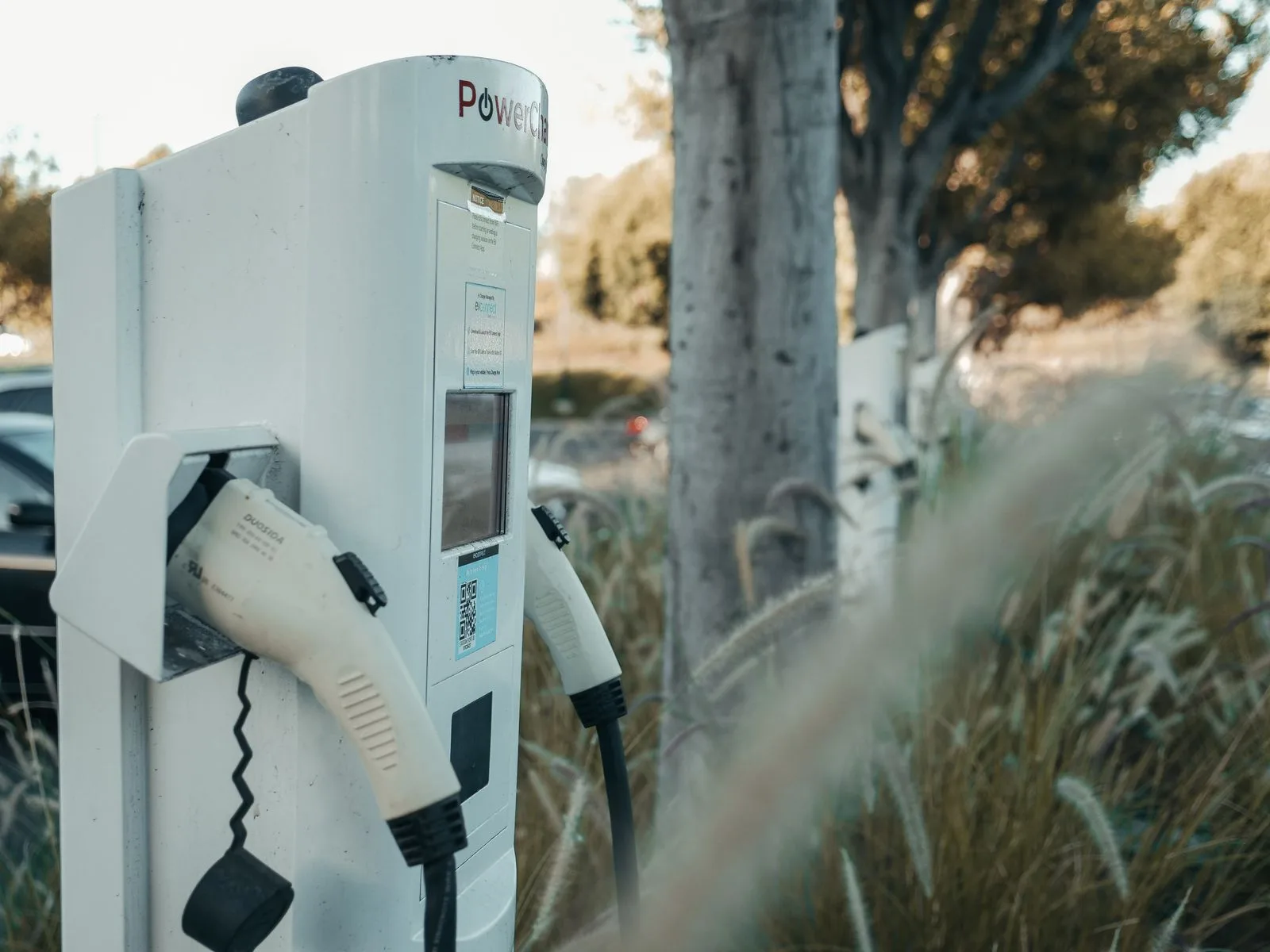 EV charging station with two connectors in a parking area