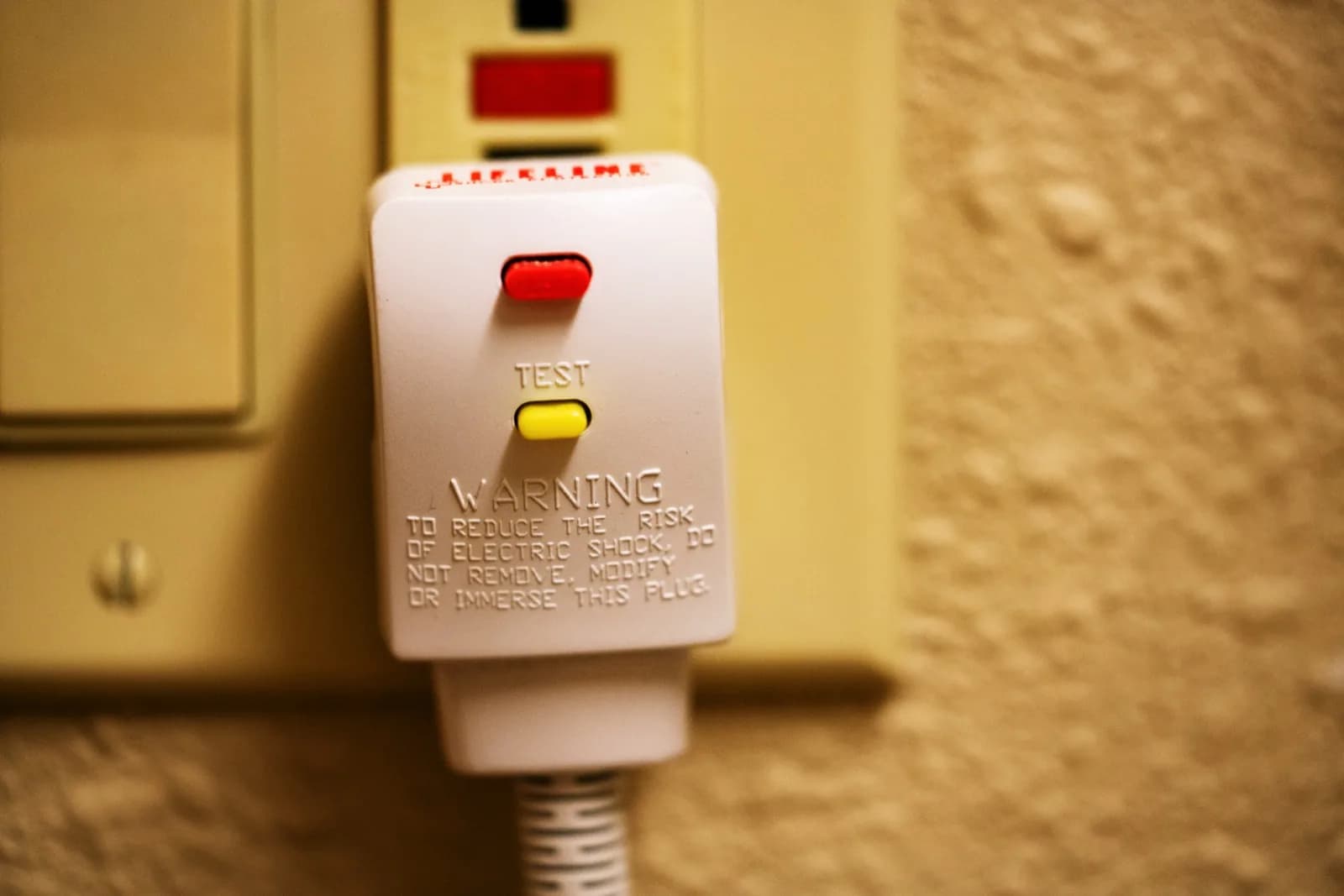 Portable plug-in GFCI adapter with its test and reset buttons visible