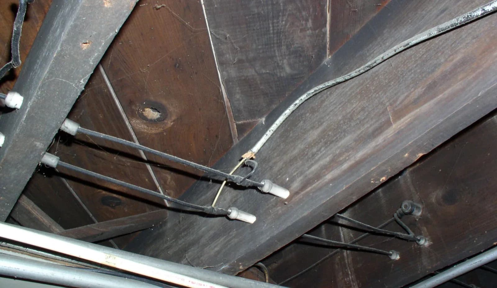 Old knob-and-tube wiring still in place in an attic