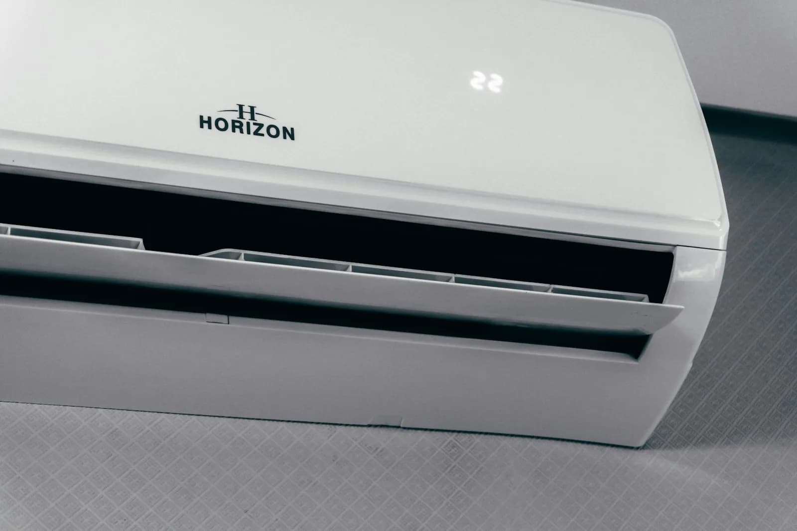 Close view of a ductless mini-split indoor head unit mounted on an interior wall
