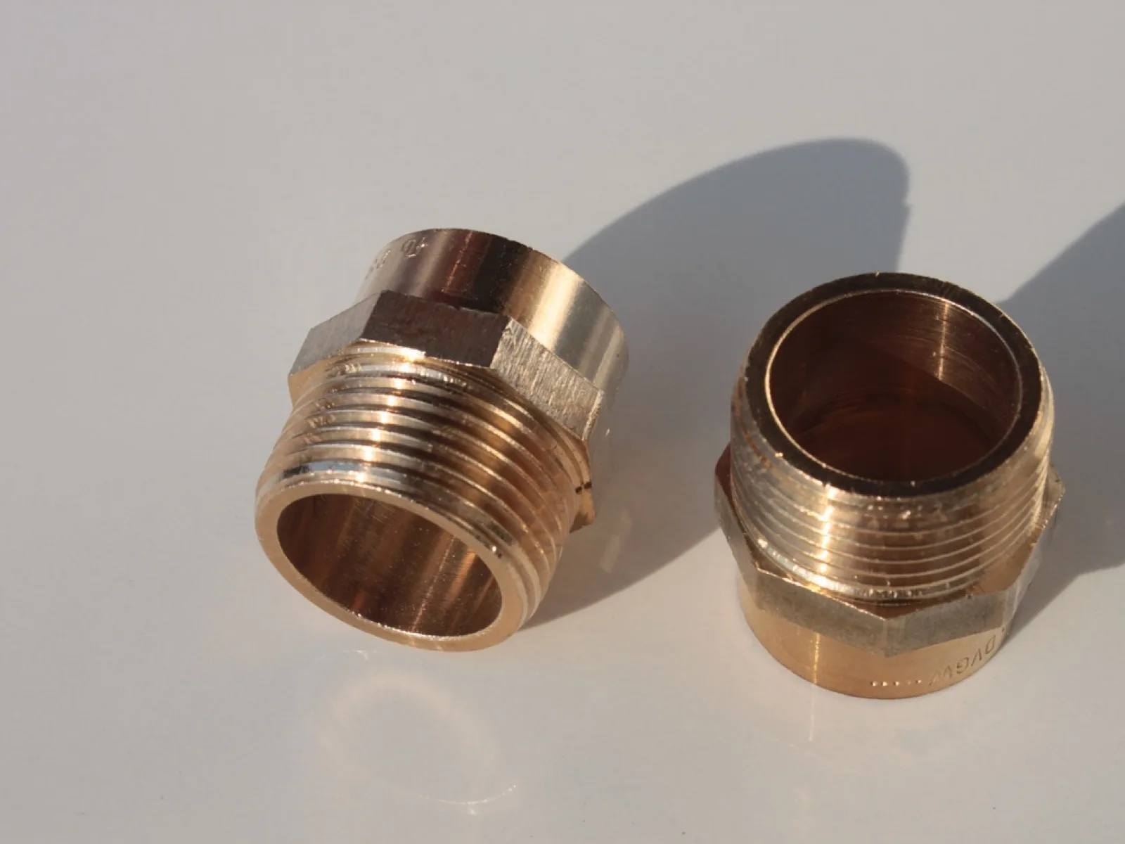 Threaded brass pipe adapters used to join copper plumbing lines
